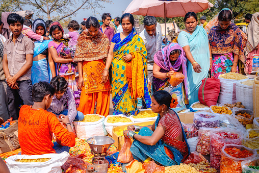 New Delhi, India - March 9, 2014: Women selling spices and seeds at the Chadni Chowk spice markets in Delhi, India.