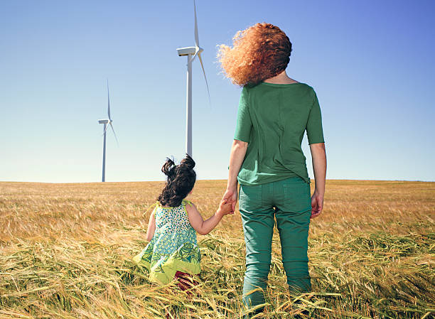 mutter und kind im getreidefeld mit windkraftanlagen - fuel and power generation power wind power supply stock-fotos und bilder