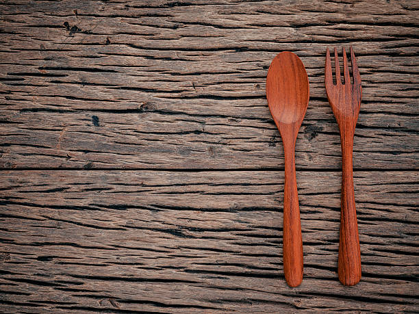 istock Fork and spoon on grunge wood food background concept . 611099116
