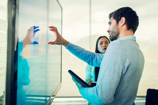 istock Colleagues talking in front of a screen with a graph 611101182