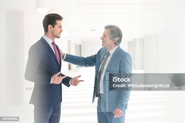 Businessmen Having Discussion In New Office Stock Photo - Download Image Now - Hand On Shoulder, Mature Adult, Professional Occupation