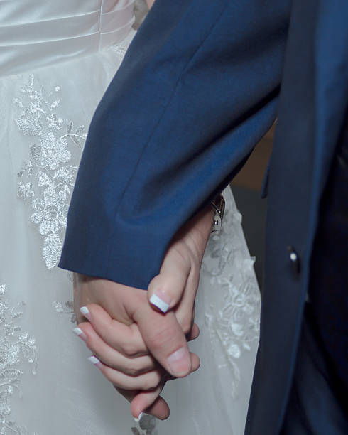 istock Older Bride and Groom holding hands 611105364