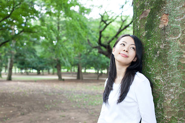 istock Japanese woman in a park 611105556