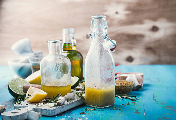 Vinaigrette and ingredients, salad dressing with oil, vinegar and mustard Homemade vinaigrette and ingredients, salad dressing with oil, vinegar and mustard, rustic style mustard fruits stock pictures, royalty-free photos & images