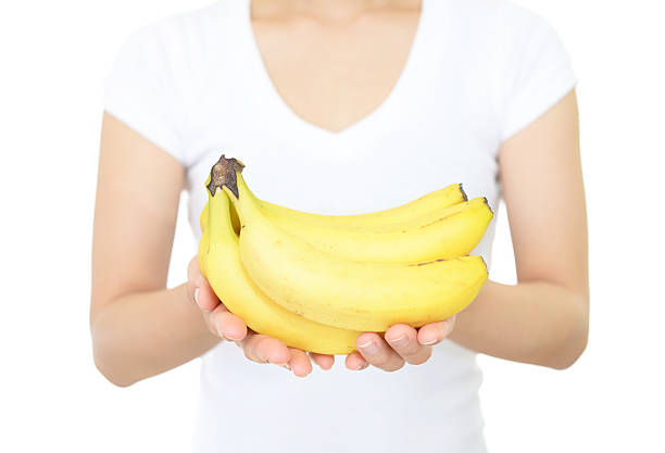 istock Woman holding bananas 611106914