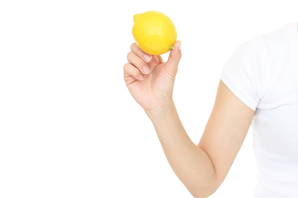istock Woman holding a lemon 611107356