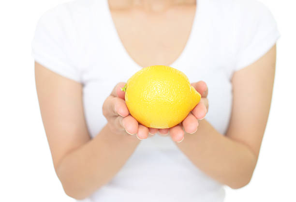 istock Woman holding a lemon 611107404
