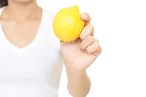 istock Woman holding a lemon 611107444