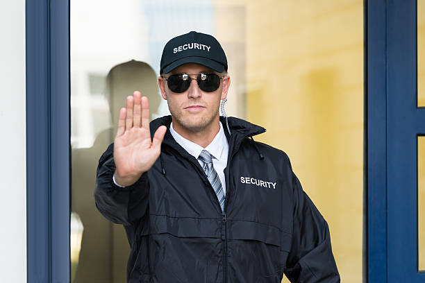 istock Male Security Guard Making Stop Sign With Hand 611109670