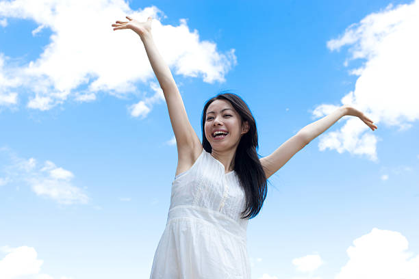 istock Japanese woman standing under a blue sky 611169878