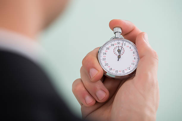 istock Person Hand Holding Stopwatch 611170764