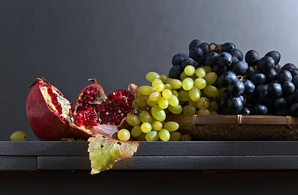 istock blue and green grapes with pomegranate 611171330