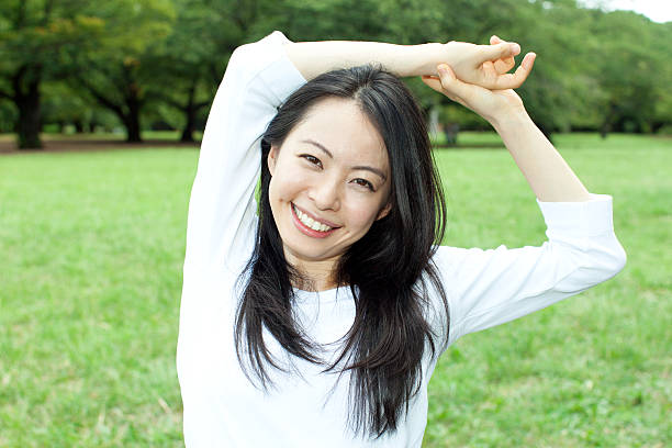 istock Japanese woman in a park 611171476