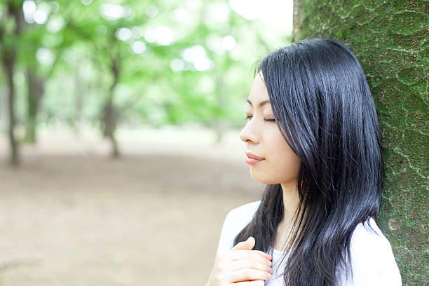 istock Japanese woman in a park 611171674