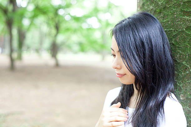 istock Japanese woman in a park 611171752