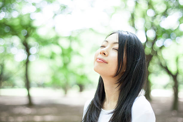 istock Japanese woman in a park 611172394
