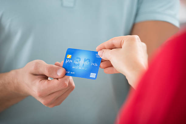 istock Salesman Taking Credit Card From Customer 611172460