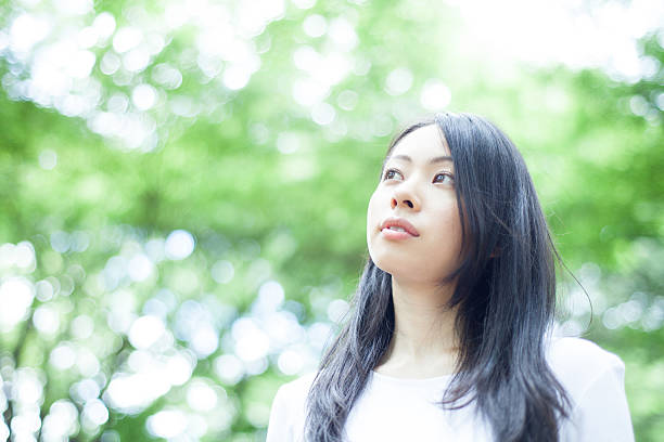 istock Japanese woman in a park 611172494