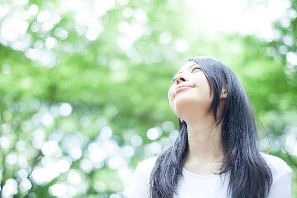 istock Japanese woman in a park 611172528