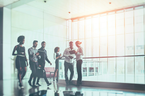 Business people walking in the office building lobby.