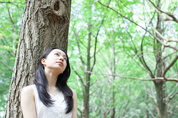 istock Japanese woman in a park 611172882