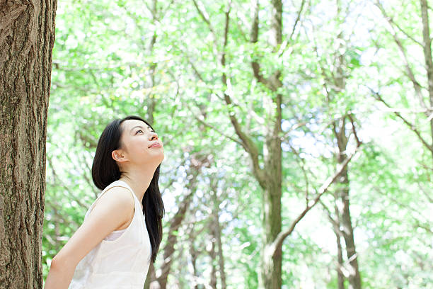 istock Japanese woman in a park 611172998