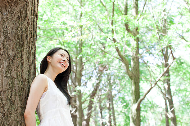 istock Japanese woman in a park 611173018