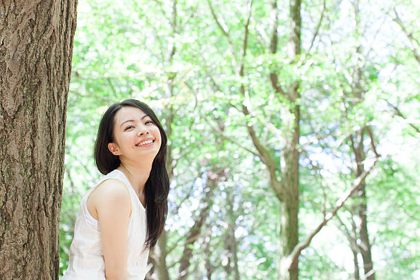 istock Japanese woman in a park 611173052