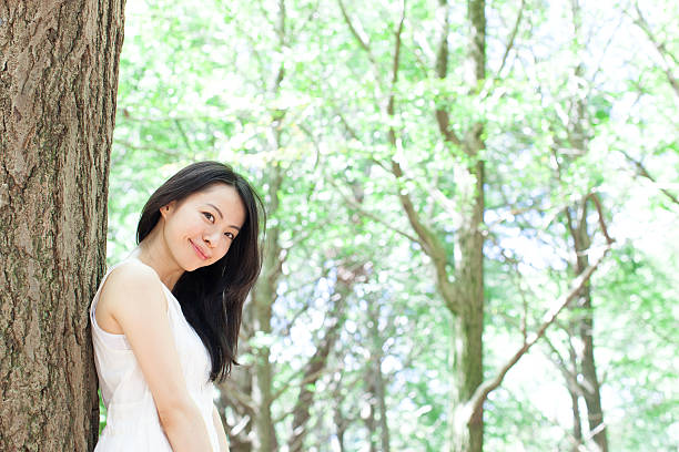istock Japanese woman in a park 611173074