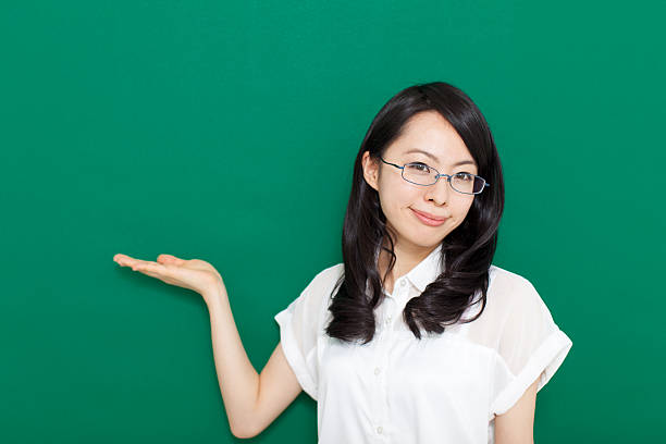 istock Japanese woman wearing glasses making gestures 611175338