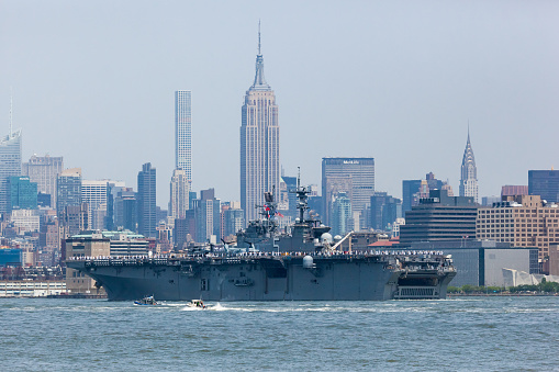 New York, New York, USA - May 25, 2016: The USS Bataan Aircraft Carrier travels the Hudson River between Jersey City and Manhattan during the Parade of Ships for Fleet Week, 2016.