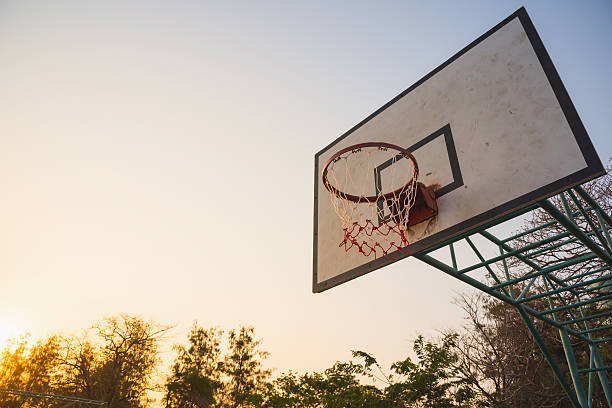 istock Basketball hoop in park in the evening 611177398