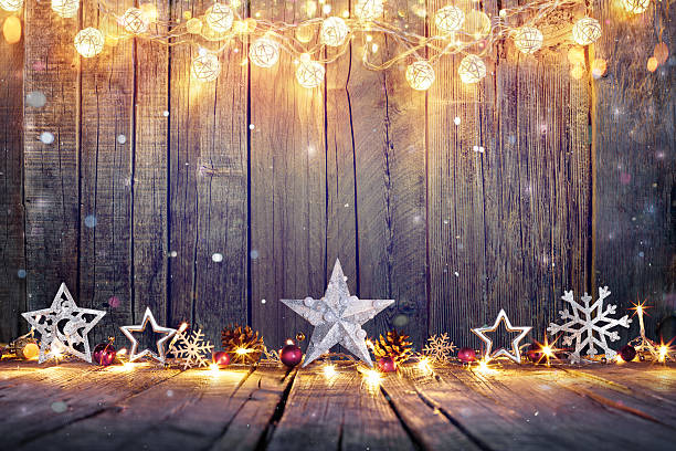 Vintage Christmas Card With Lights And Star On Table Vintage Christmas Decoration With Stars And Lights On Wooden Table floral garland photos stock pictures, royalty-free photos & images