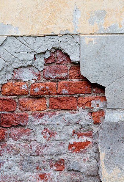 Old broken wall with visible bricks texture stock photo
