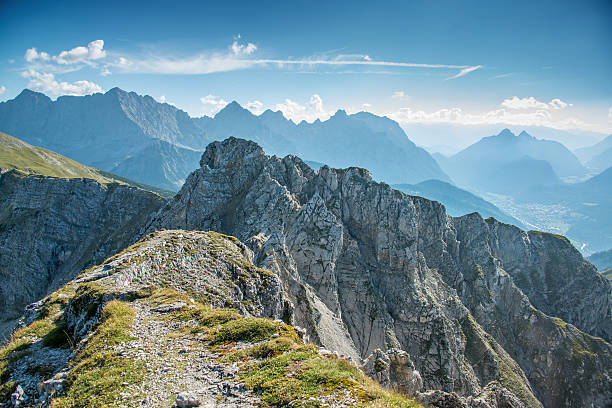 Path towards mountain ridge with panoramic view stock photo