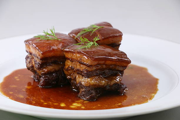 istock Braised pork meat in Chinese style with herbs on white 611180078