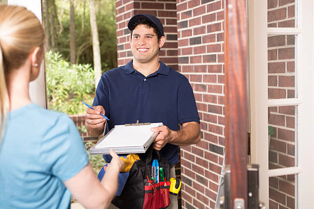 istock Repairman at customer's front door. 611180810