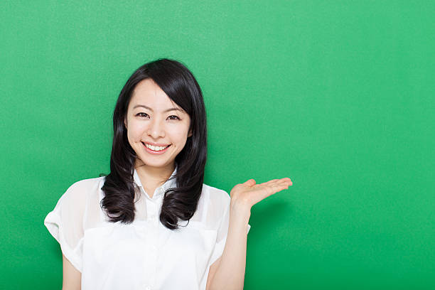 istock Japanese woman making gestures in green background 611180920