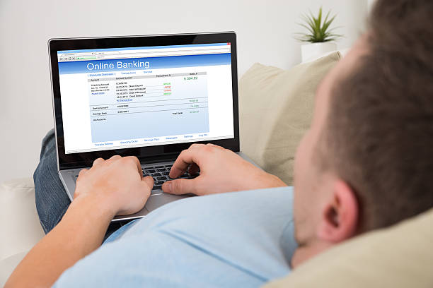 istock Man Using Online Banking On Laptop At Home 611180922