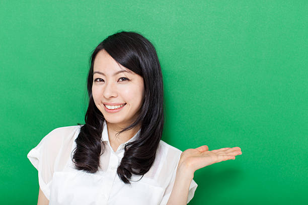 istock Japanese woman making gestures in green background 611180938