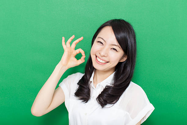 istock Japanese woman making gestures in green background 611181058