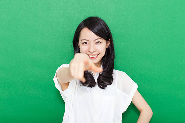 istock Japanese woman making gestures in green background 611181198