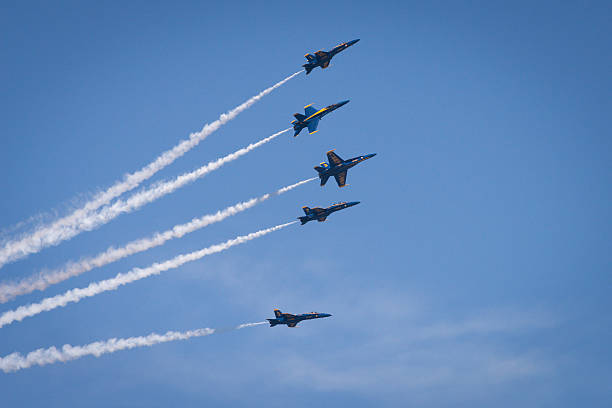 Blue Angels Seattle, USA - August 5, 2016: The Elite US Navy Blue Angels flying over Seafair during the airshow over Lake Union mid-day. in synch stock pictures, royalty-free photos & images