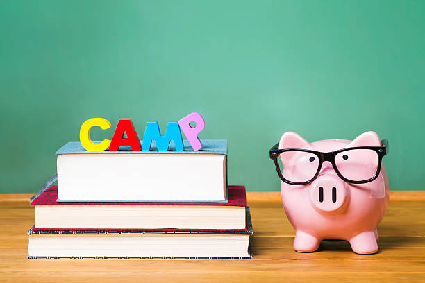 istock Educational summer camp theme with pink piggy bank 611183014