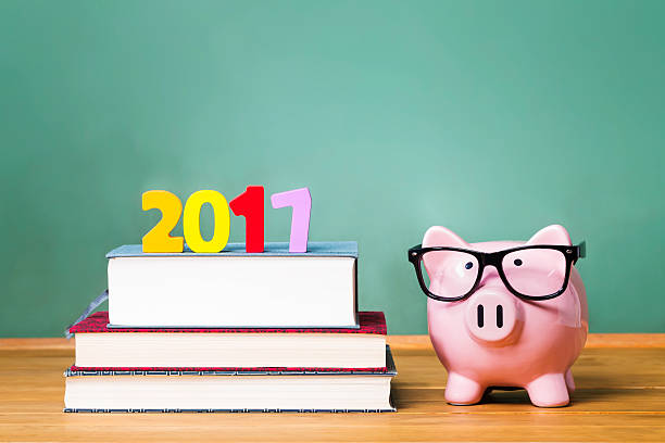 istock Class of 2017 theme with textbooks and piggy bank 611183020