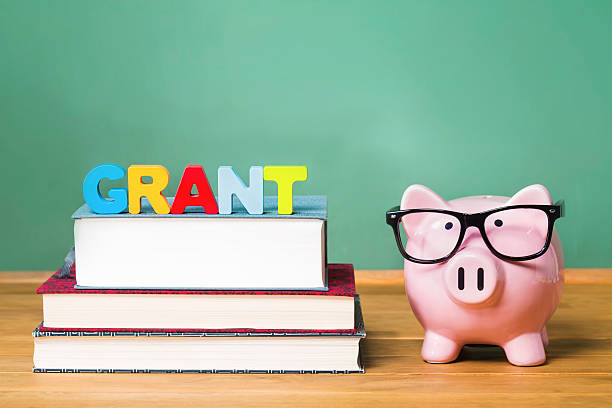 istock Education grant theme with pink piggy bank on top 611183032