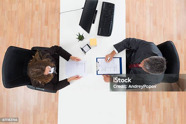 Businessman Interviewing Female Candidate Stock Photo - Download Image Now - Job Interview, Directly Above, High Angle View