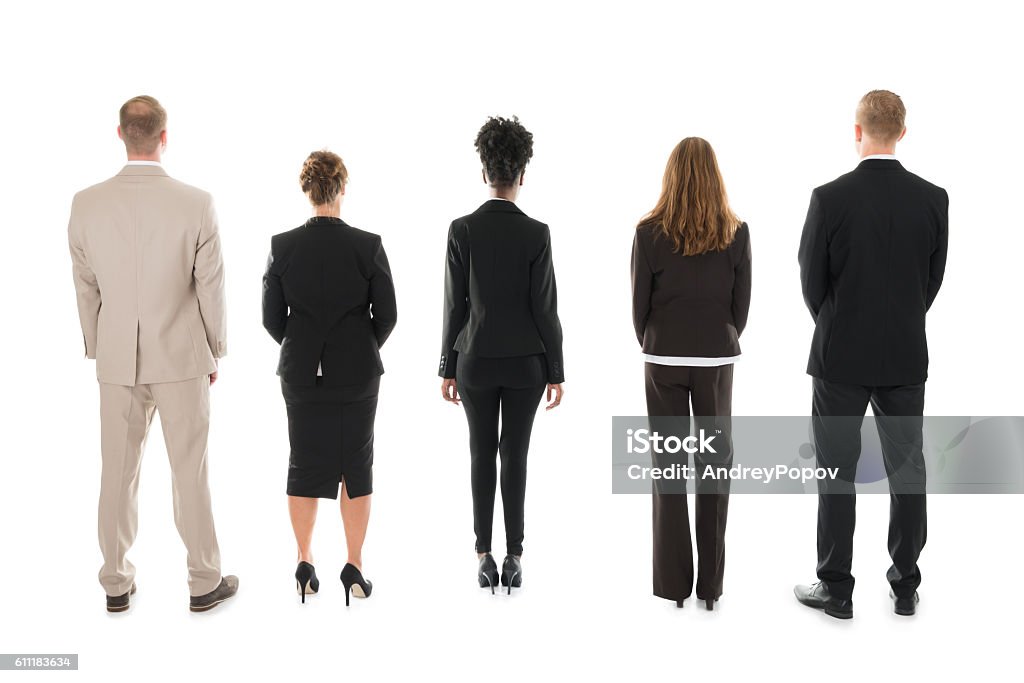 Business Team Standing Against White Background Full length rear view of business team standing against white background Rear View Stock Photo