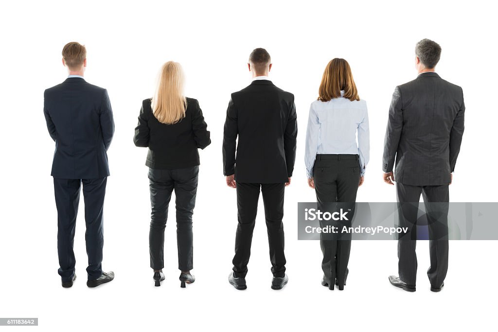 Business People Standing Against White Background Full length rear view of business people standing against white background Rear View Stock Photo