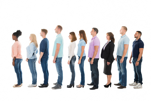 Full length side view of creative business people standing in row against white background